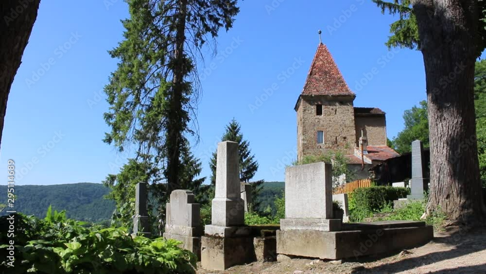SIGHISOARA, ROMANIA - June 28, 2017: Static View of the graves from the centuries-old Saxon cemetery and on background the roofs tower, destroyed (1241) rebuilt (1350). Hd video SIGHISOARA, ROMANIA - June 28, 2017: Static View of the graves from the centuries-old Saxon cemetery and on background the roofs tower, destroyed (1241) rebuilt (1350). Hd video