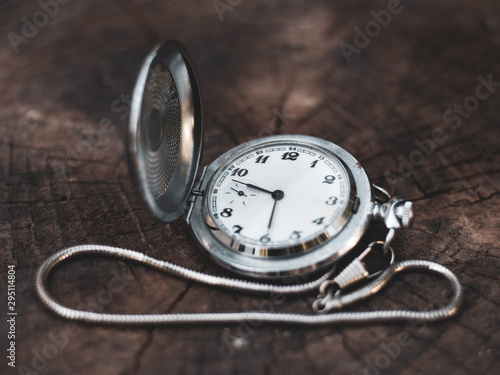 old pocket watch on a wooden background