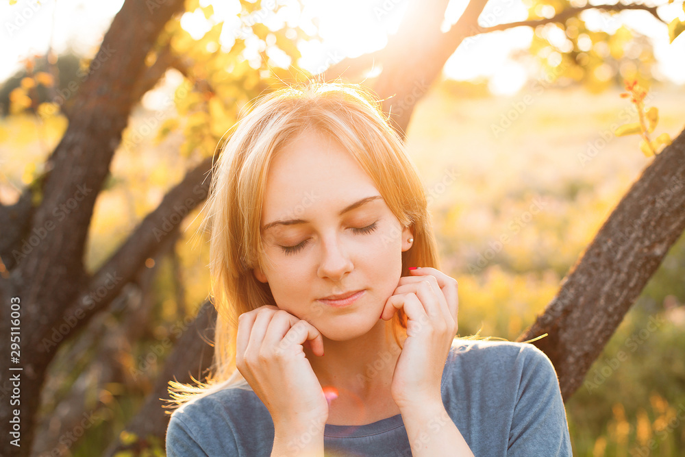 Portrait of beautiful young woman near the tree outdoors Portrait of beautiful young woman near the tree outdoors