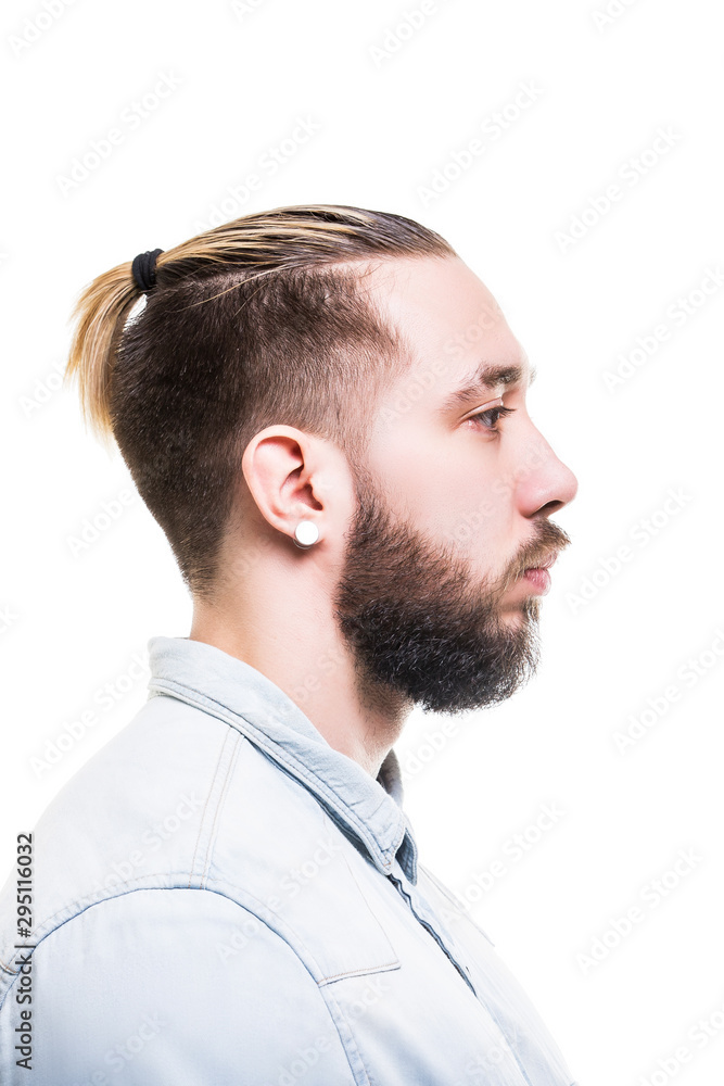 Obraz premium Closeup profile portrait of bearded caucasian man wearing shirt with serious look isolated at white background.