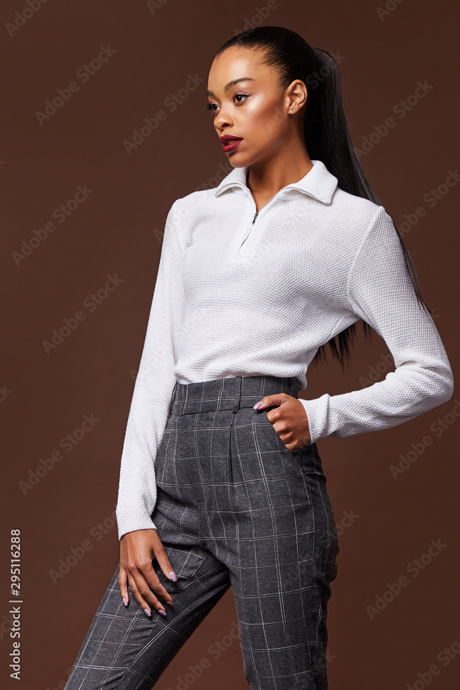 Beautiful sexy woman long brunette hair glamour model wear pants and sweater work office style dress code accessory jewelry studio background fashion party meeting date makeup cosmetic shop. Beautiful sexy woman long brunette hair glamour model wear pants and sweater work office style dress code accessory jewelry studio background fashion party meeting date makeup cosmetic shop.
