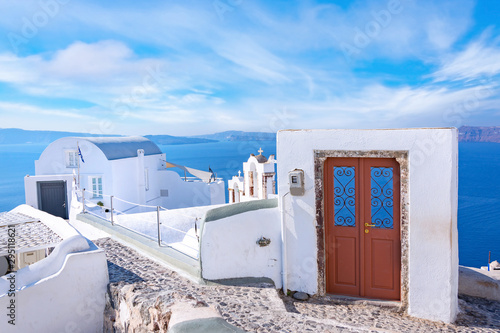 Traditional white architecture and door overlooking the Mediterranean sea in ...