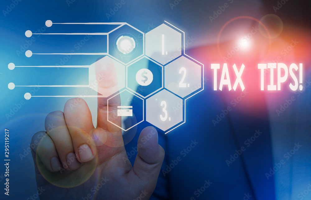 Writing note showing Tax Tips. Business concept for compulsory contribution to state revenue levied by government Male wear formal suit presenting presentation smart device Writing note showing Tax Tips. Business concept for compulsory contribution to state revenue levied by government Male wear formal suit presenting presentation smart device