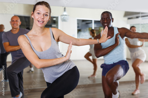 Group of happy adult people enjoying active dance in studio © JackF
