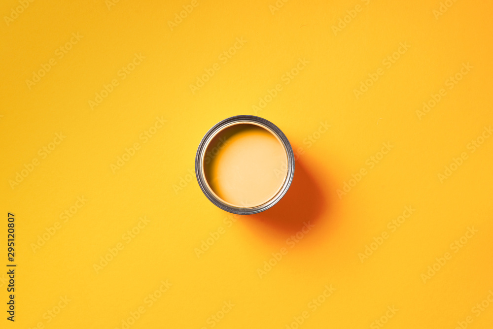 Open paint can with on trendy yellow background. Top view, copy space. Appartment renovation, repair, building and home design concept. Open paint can with on trendy yellow background. Top view, copy space. Appartment renovation, repair, building and home design concept.