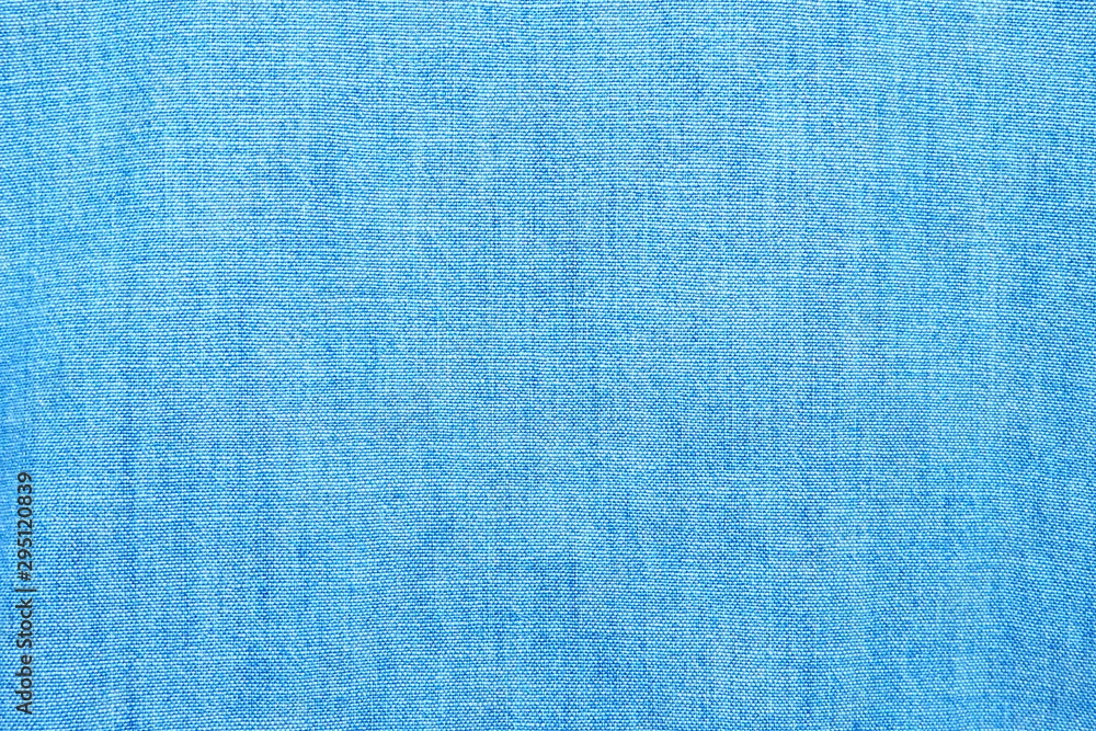 Closeup of cotton mixed with polyester fabric in bright blue and turquoise tone for textile texture and simple cool banner background Closeup of cotton mixed with polyester fabric in bright blue and turquoise tone for textile texture and simple cool banner background