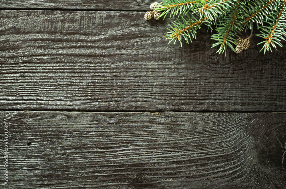 Christmas fir tree branches and pine cones on wooden dark, black background. Christmas fir tree branches and pine cones on wooden dark, black background.