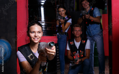 Smiling girl with laser guns  took aim and having fun with friends © JackF