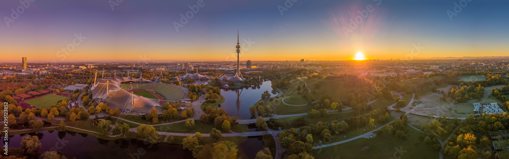 Impressive total view over Munich at sunset with the Olympic Park. - obrazy, fototapety, plakaty 