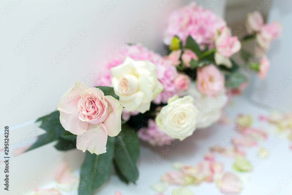 Wedding decorations. Holiday decoration vase with fresh flowers near the wedding arch. Pink roses and carnations