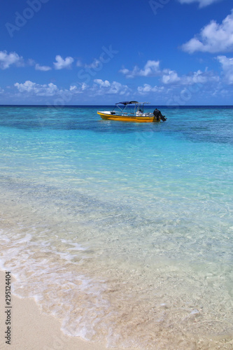 Fototapeta Naklejka Na Ścianę i Meble -  Tourist boat anchored at Gee island in Ouvea lagoon, Loyalty Islands, New Caledonia