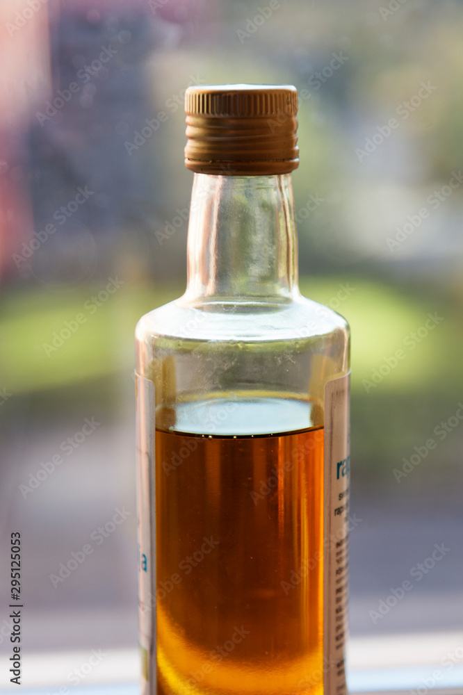 a bottle of the finest organic olive oil standing in the window of the office a bottle of the finest organic olive oil standing in the window of the office