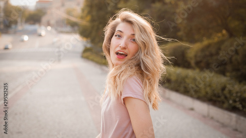 Young happy woman with beautiful hair walking on the street.