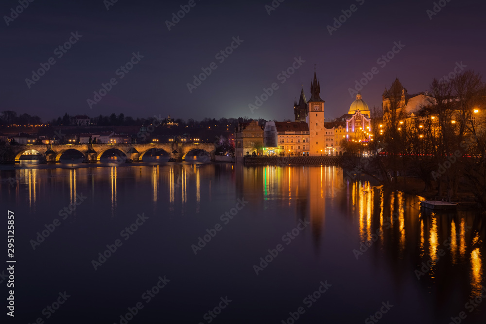 Scenic winter evening view of the Old Town ancient architecture and Vltava river pier in Prague, Czech Republic