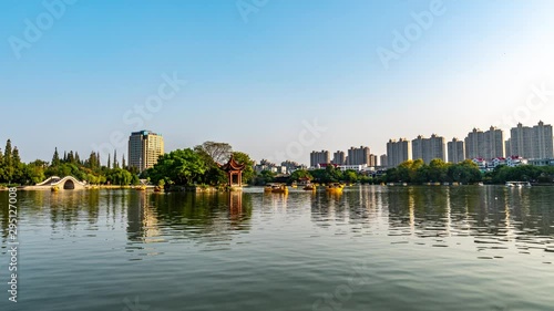  TIMELAPSE Wuhu Anhui Dajing Lake at Jinghu Gongyuan Park with Tourists and Visitors Sailing with Boats During Sunset photo