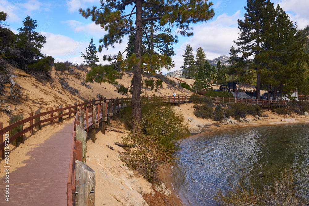 Tourist walking down the board walk in Sand Harbor State Park in the fall months of the year