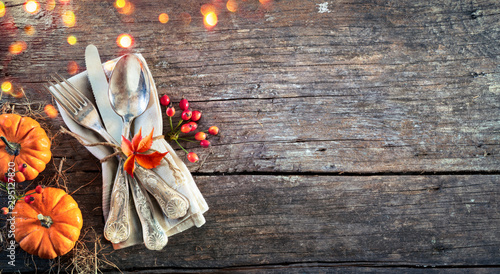 Thanksgiving Place Setting - Rustic Table With Silverware And Pumpkins photo