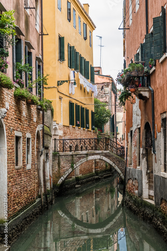 Reflection of the bridge in the narrow Venetian canal
