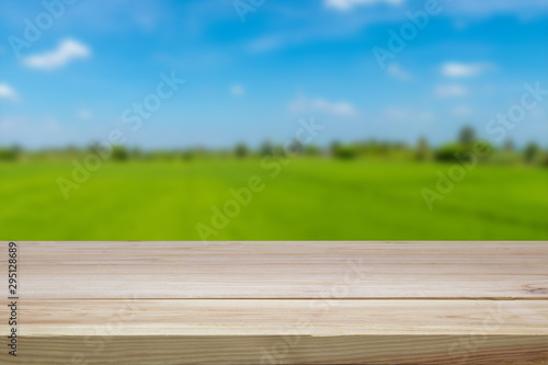 A wooden table on a blurred green background