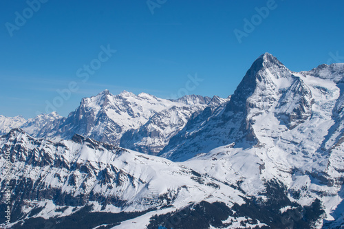 Swiss mountain peak after snowfall with panoramic view of Murren Jungfrau ski region. © Racoonbtc