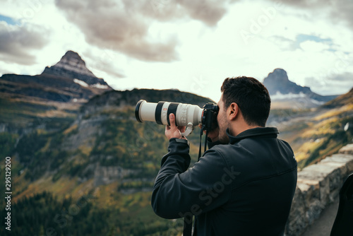 Man taking a photo of the Landscape at Logan Pass, Montana. photo