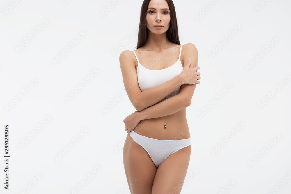 Sensual woman in underwear looking at camera alluringly - obrazy, fototapety, plakaty 