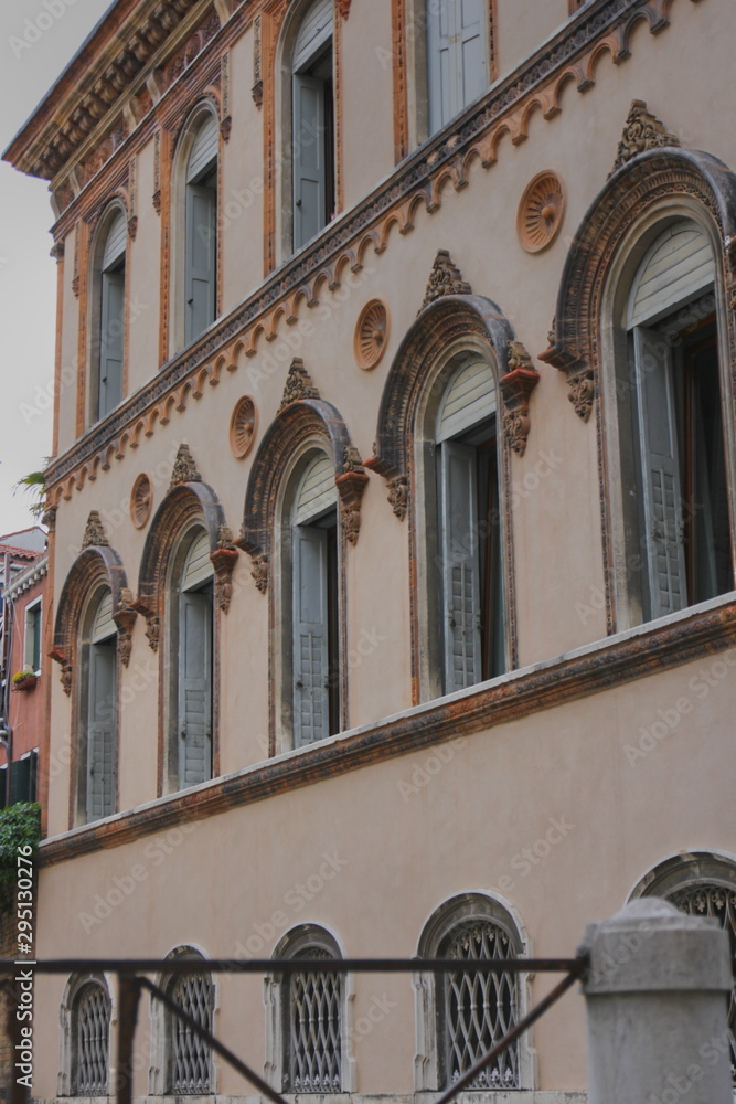 Vintage arched windows, pink apartment building in Venice