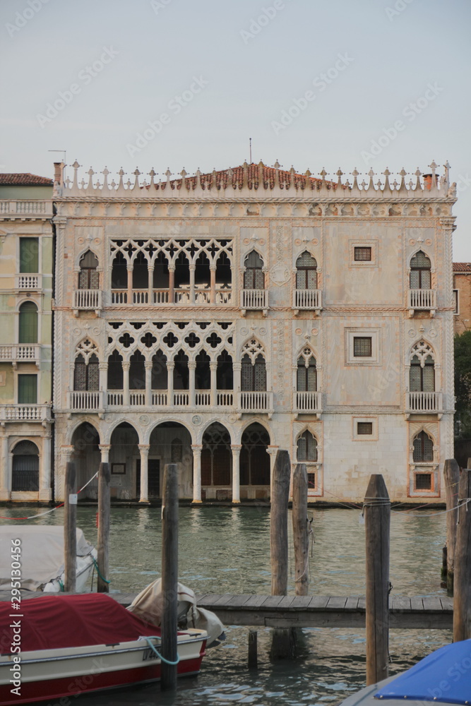 A beautiful openwork building in Venice, the building can be seen between two boats and water