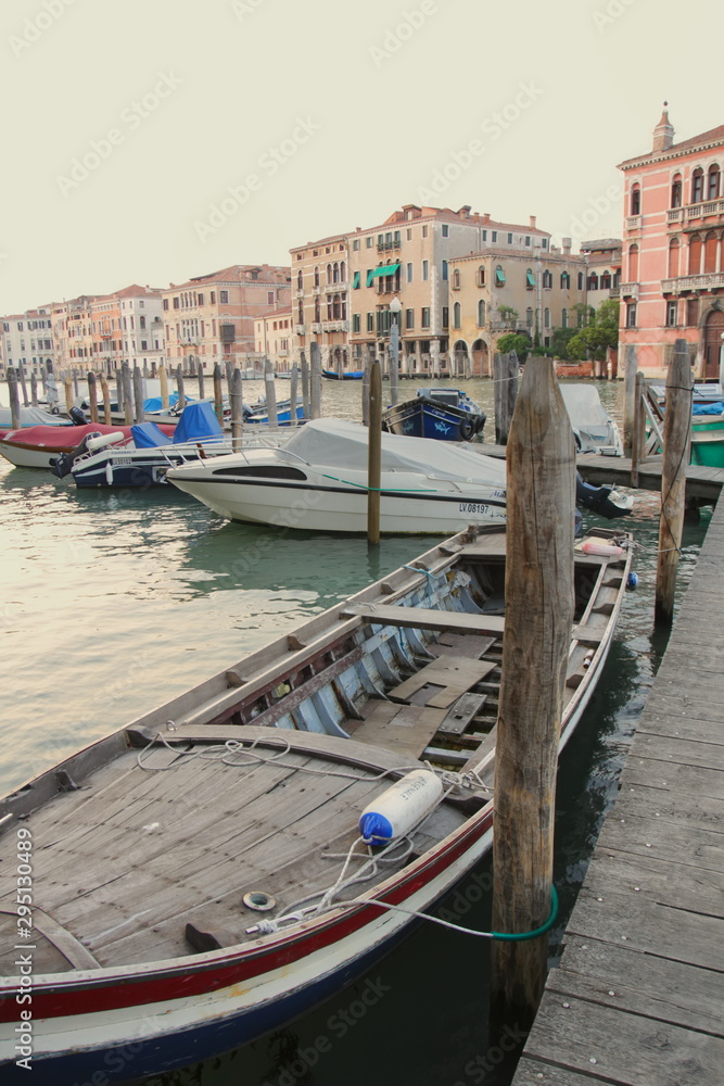 Wooden boat near the pier, Venice, tether posts