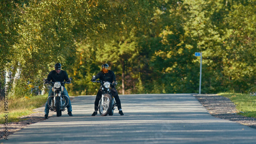 Two bikers on their bikes are standing on the road © KONSTANTIN SHISHKIN