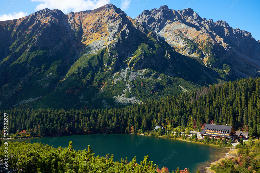 The autumn Poprad lake surrounded by peaks and forests in High Tatras mountains, Slovakia