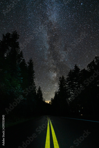 THe milky way and starts lighting up on top of the road just beside Macdonald Lake, Montana.