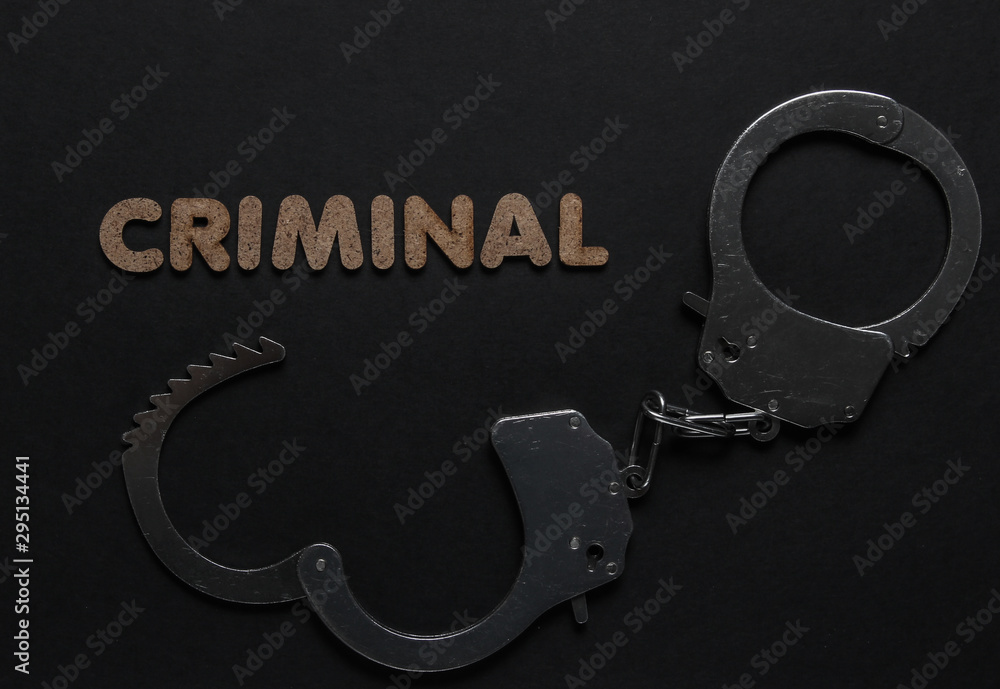 Steel handcuffs on black background. Criminal, corruption concept Steel handcuffs on black background. Criminal, corruption concept