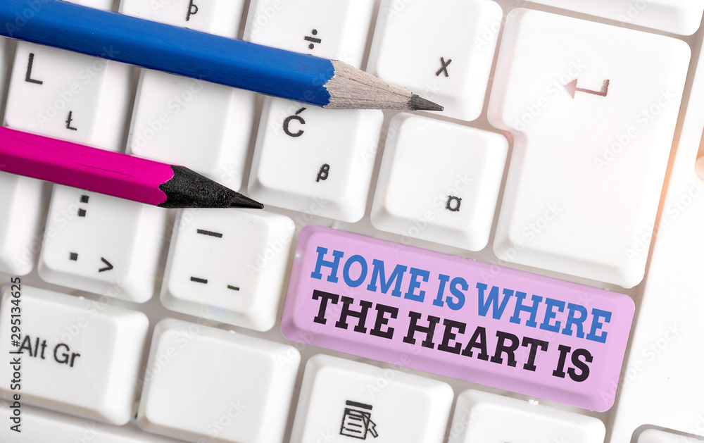 Handwriting text Home Is Where The Heart Is. Conceptual photo Your house is where you feel comfortable and happy White pc keyboard with empty note paper above white background key copy space Handwriting text Home Is Where The Heart Is. Conceptual photo Your house is where you feel comfortable and happy White pc keyboard with empty note paper above white background key copy space