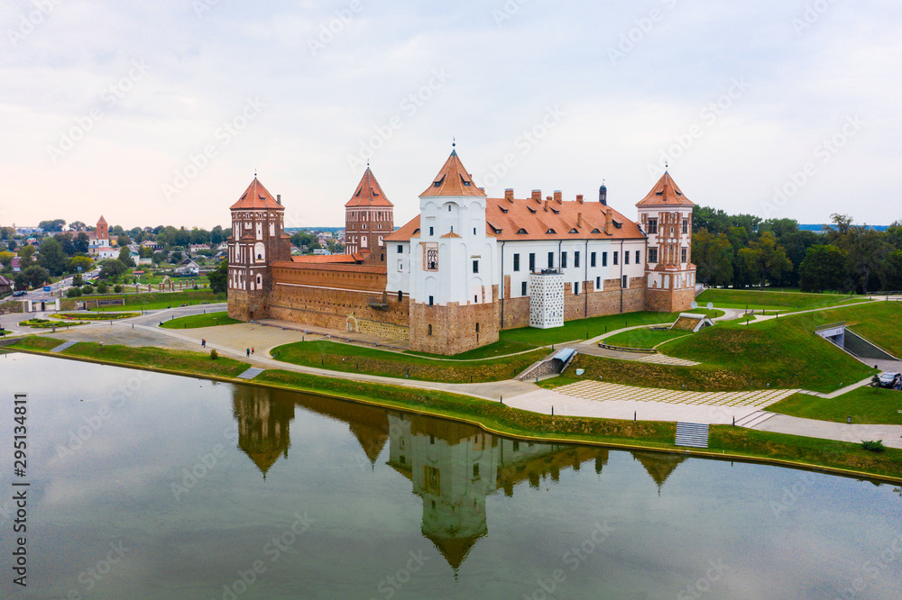Mirsky Castle and its reflection in the lake in summer. Mirsky Castle and its reflection in the lake in summer.