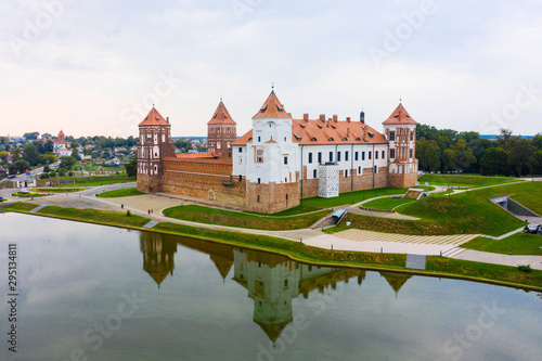 Mirsky Castle and its reflection in the lake in summer.