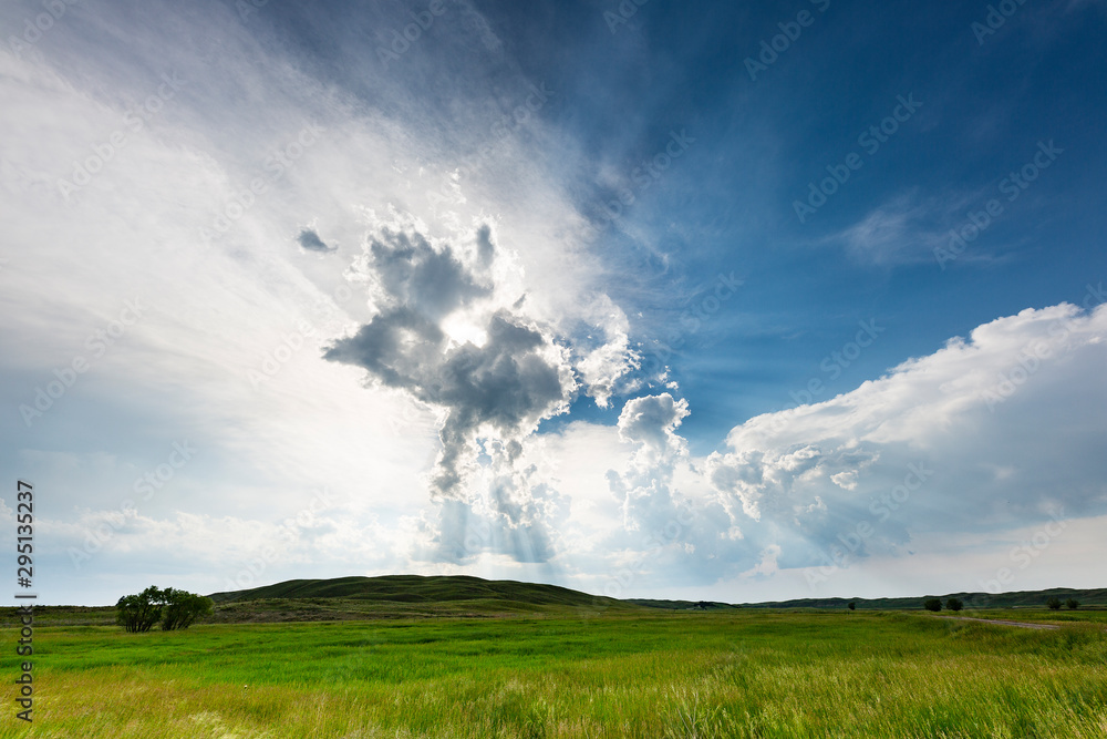 Dramatic clouds over green grassland. Dramatic clouds over green grassland.