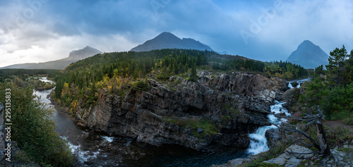 Panoramic view of the Swiftcurrent Falls at sunrise with the mountains in the Background, Montana.