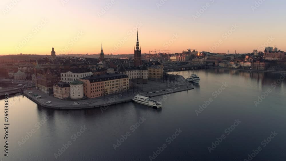 Aerial view of Stockholm skyline cityscape at sunrise. Drone shot flying over water, Riddarholmen island city buildings and church. Gamla stan, Old Town landmark, Capital of Sweden Aerial view of Stockholm skyline cityscape at sunrise. Drone shot flying over water, Riddarholmen island city buildings and church. Gamla stan, Old Town landmark, Capital of Sweden