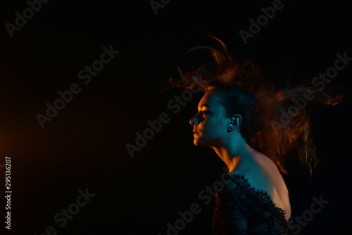 girl with red hair on a black background