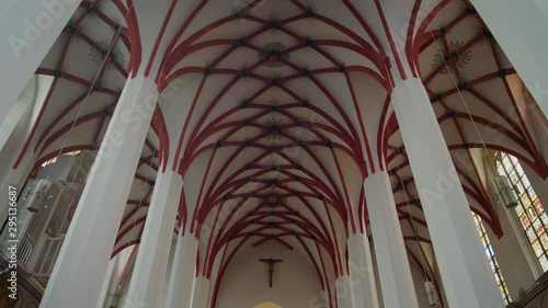 Christian Catholic St. Thomas Church (Thomaskirche) interior in Leipzig, Germany, Europe. Remains of Johann Sebastian Bach are here. 4K Background Tilt Low Angle Indoor Shot photo