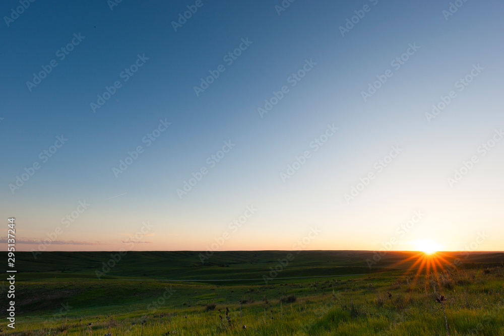 Sun setting on the horizon in Thedford, Nebraska, USA.