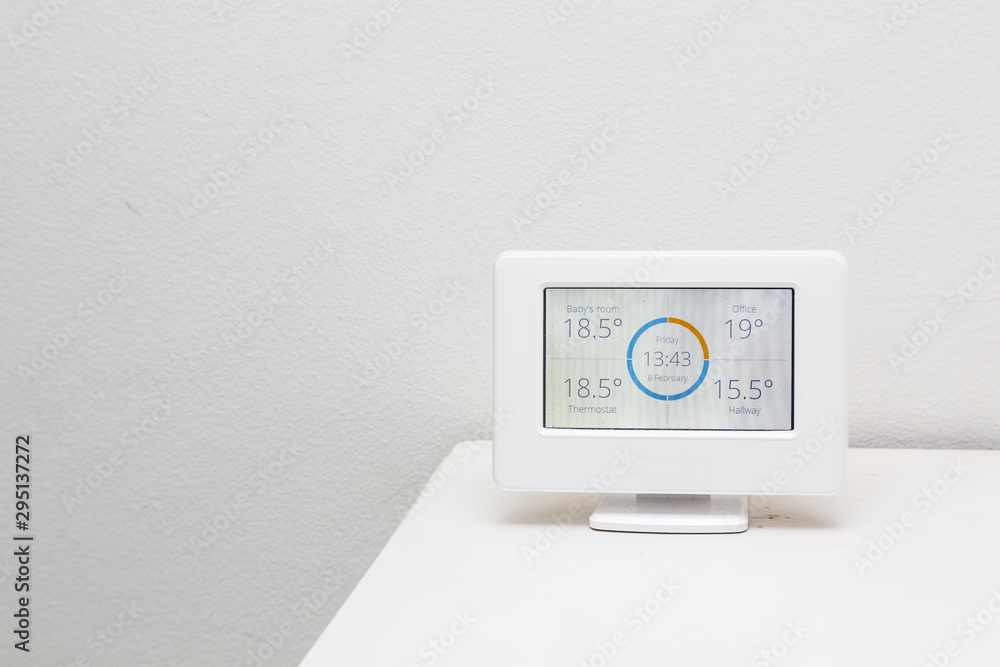 A wireless thermostat showing the temperatures in different rooms of a house. A wireless thermostat showing the temperatures in different rooms of a house.