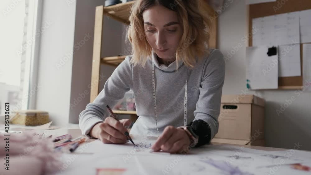designer of clothes makes an outline of clothes with a felt-tip pen designer of clothes makes an outline of clothes with a felt-tip pen