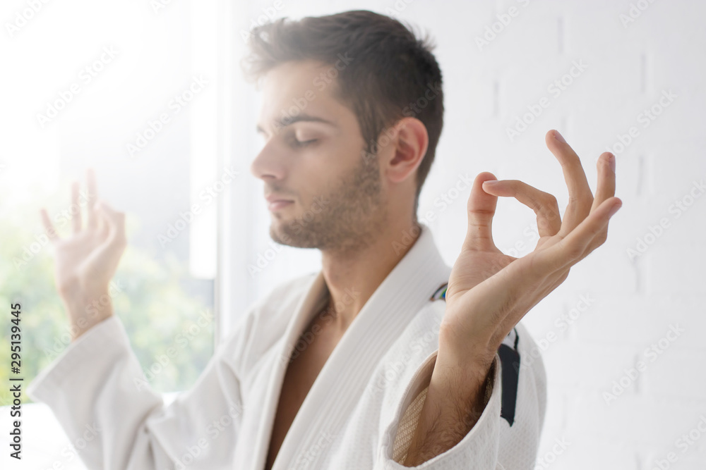man hand in foreground with yoga concentration and meditation gesture man hand in foreground with yoga concentration and meditation gesture