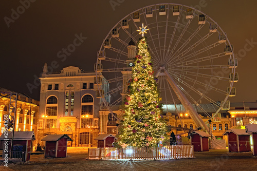 Early morning view of romantic Christmas Market with New Year Tree and Ferris wheel at Kontraktova Square (engl. the Contracts Square). Kyiv, Ukraine