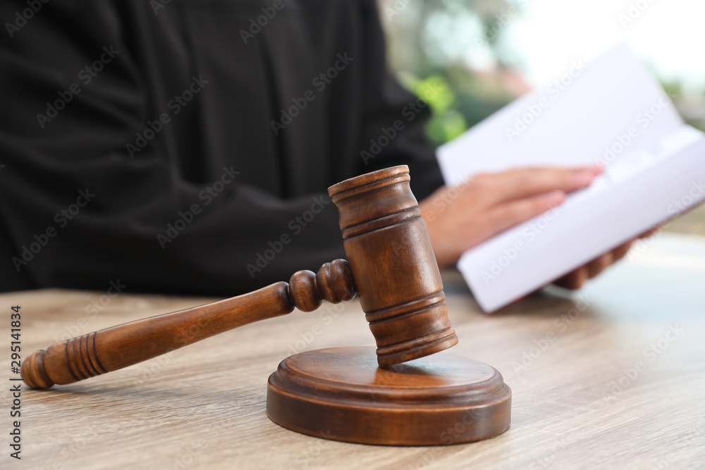 Gavel and blurred judge on background. Criminal law Gavel and blurred judge on background. Criminal law