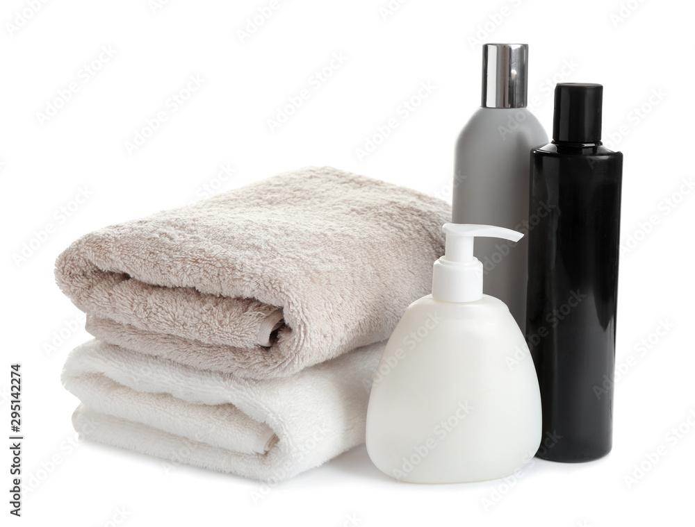 Folded soft towels and toiletries on white background Folded soft towels and toiletries on white background