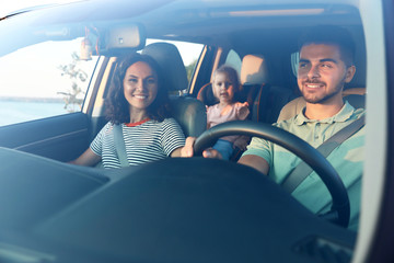 Happy family traveling by car on summer day