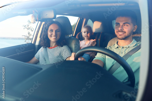 Happy family traveling by car on summer day